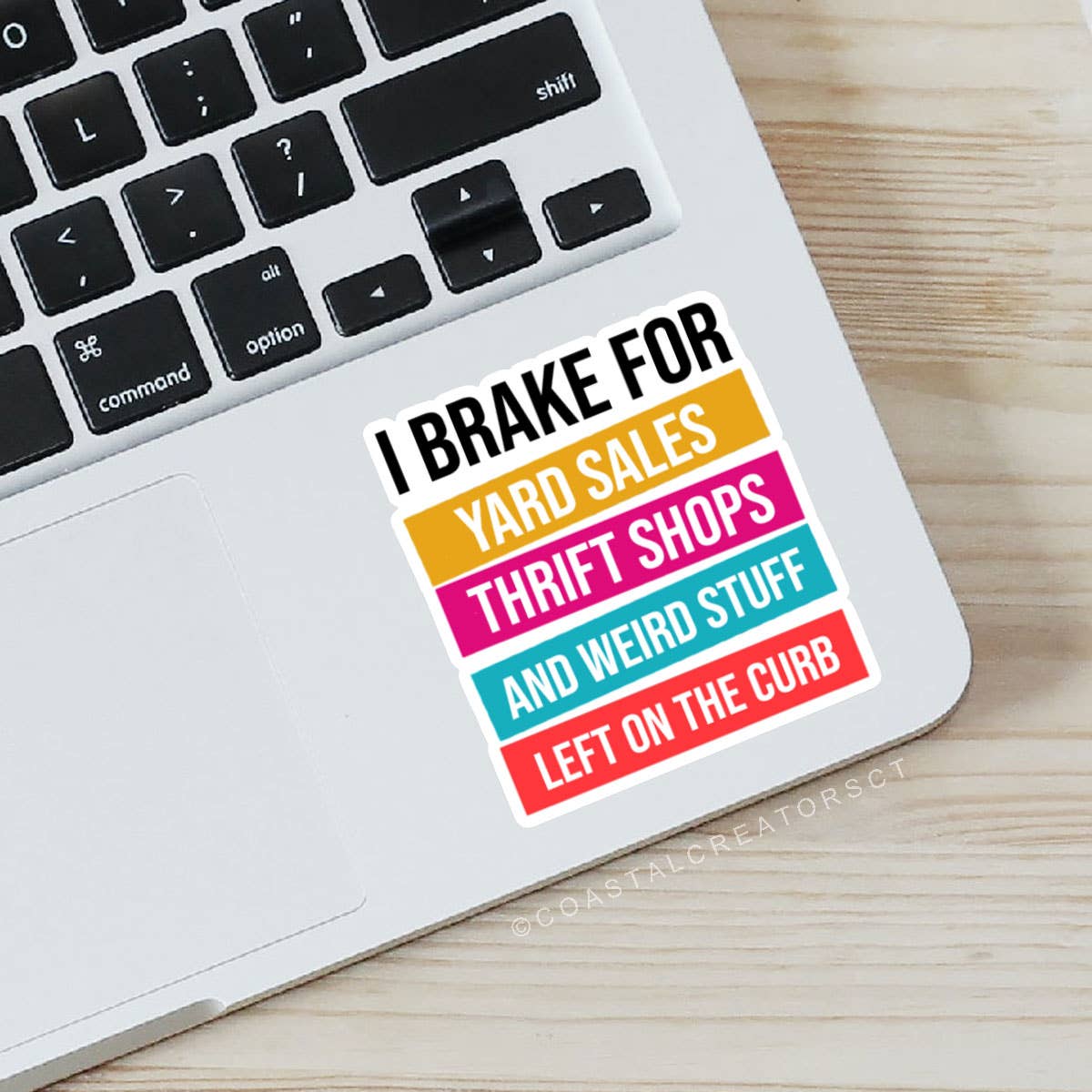 Colorful sticker on a laptop with text 'I brake for yard sales, thrift shops, and weird stuff left on the curb'. Rutledge Exchange is a boutique jewelry and antique store in Camden, SC. 
