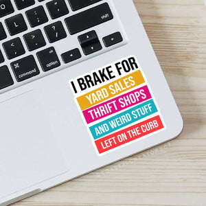 Colorful sticker on a laptop with text 'I brake for yard sales, thrift shops, and weird stuff left on the curb'. Rutledge Exchange is a boutique jewelry and antique store in Camden, SC. 