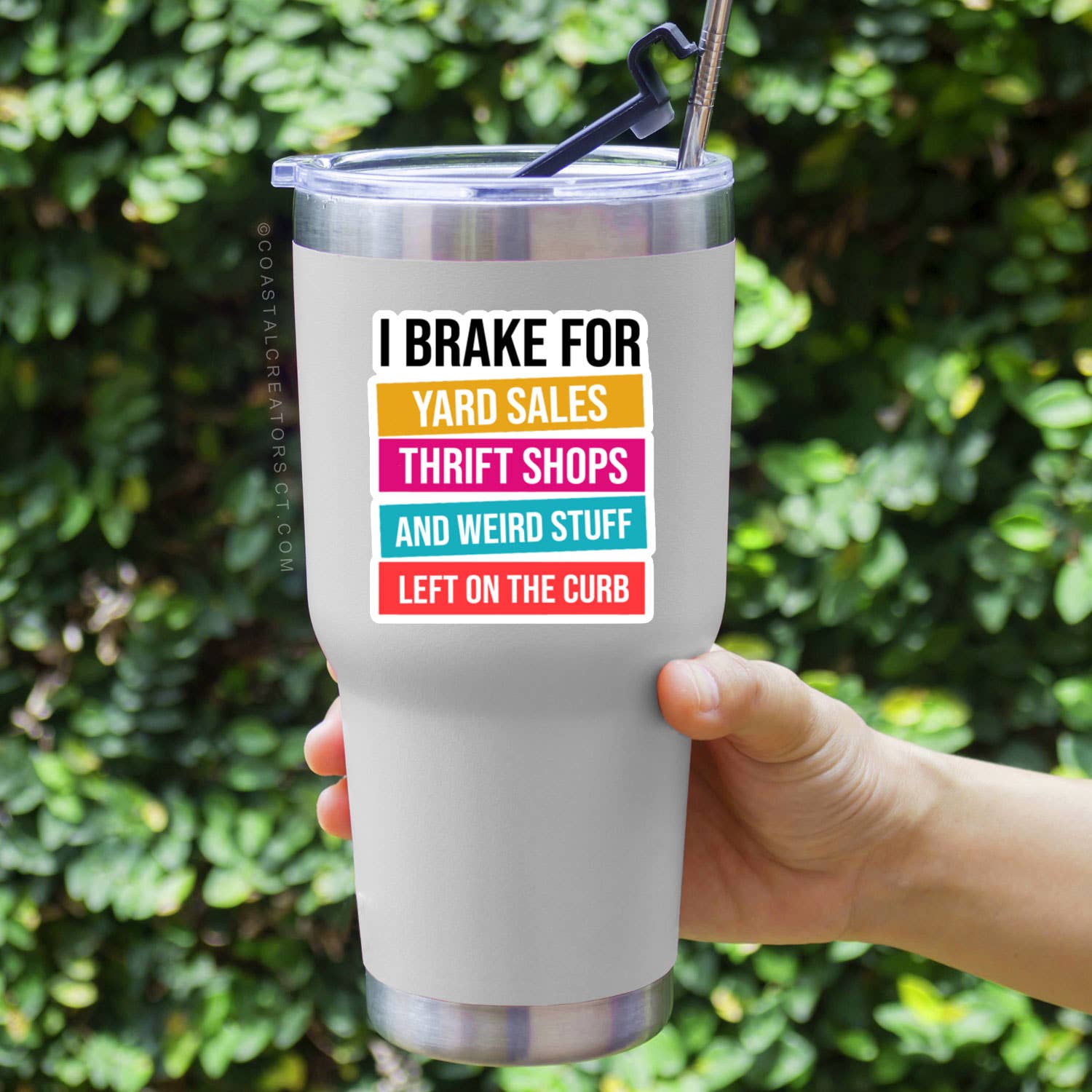 White tumbler with colorful text held in front of a green leafy background. Rutledge Exchange is a boutique jewelry and antique store in Camden, SC. 