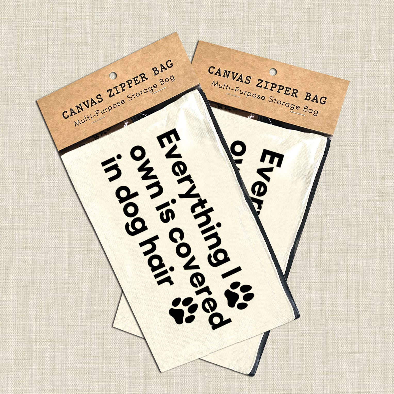 Canvas zipper bags with humorous text and paw print design on a textured surface. Rutledge Exchange is a boutique jewelry and antique store in Camden, SC. &nbsp;