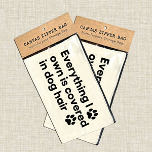 Canvas zipper bags with humorous text and paw print design on a textured surface. Rutledge Exchange is a boutique jewelry and antique store in Camden, SC. &nbsp;