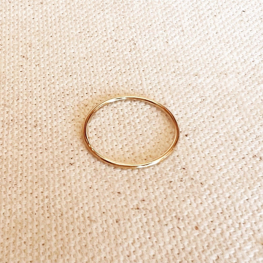 Gold ring on a beige textured fabric background. 1mm Plain Stackable Ring: Size 6 in 14k Gold Filled