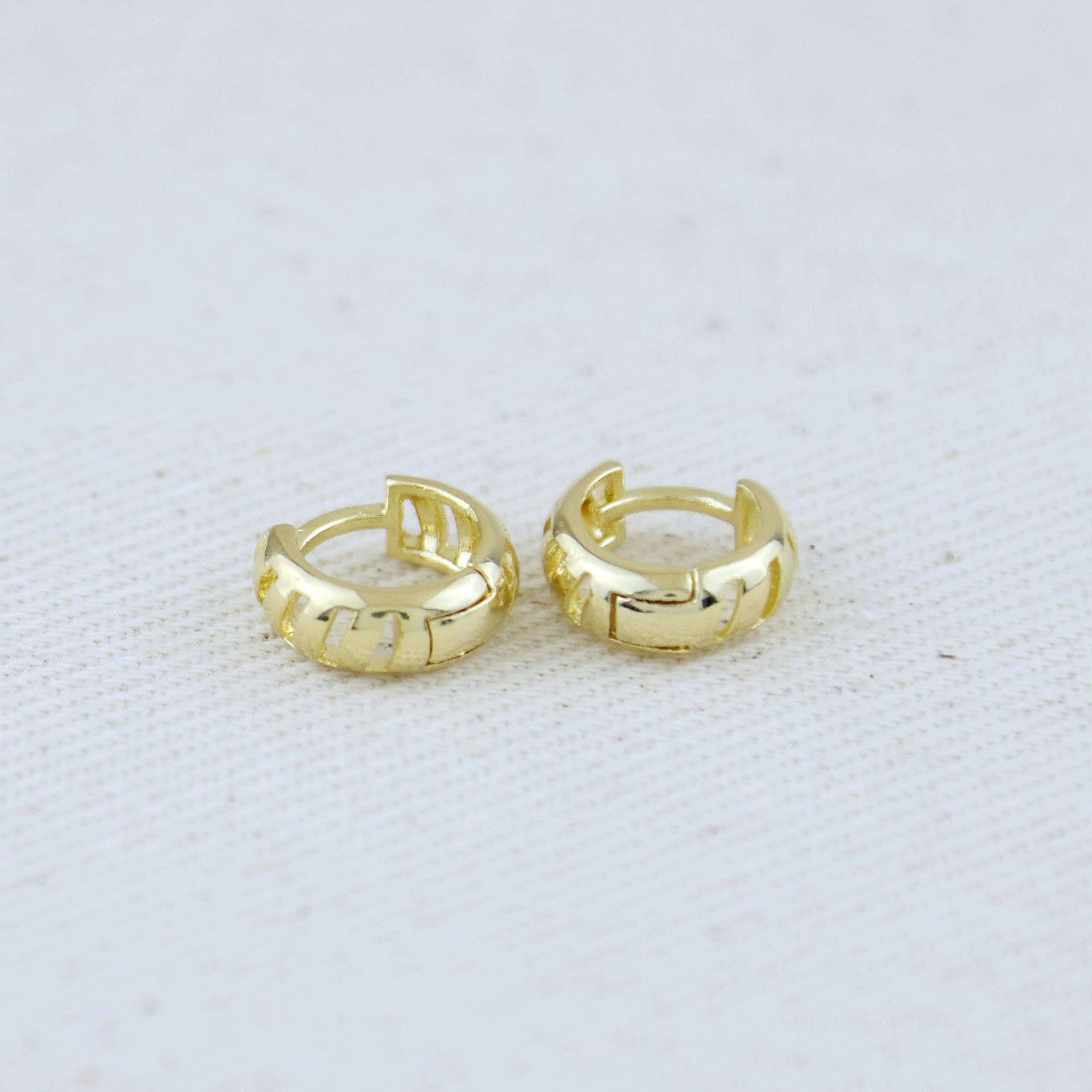 Pair of gold hoop earrings on a light gray background. Shop Rutledge Exchange for curated vintage and jewelry in Camden, SC.
