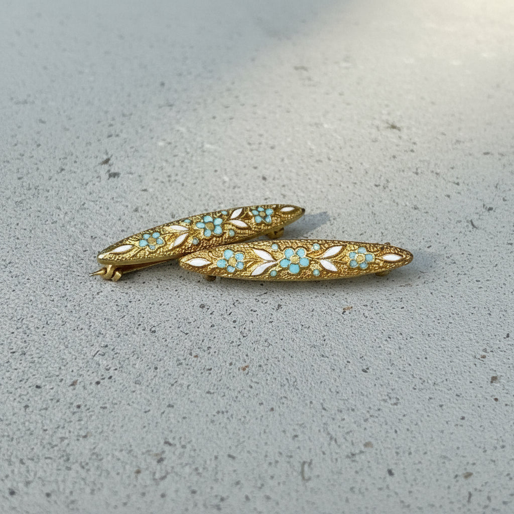 Two decorative brooches on a textured surface at Rutledge Exchange in Camden, SC