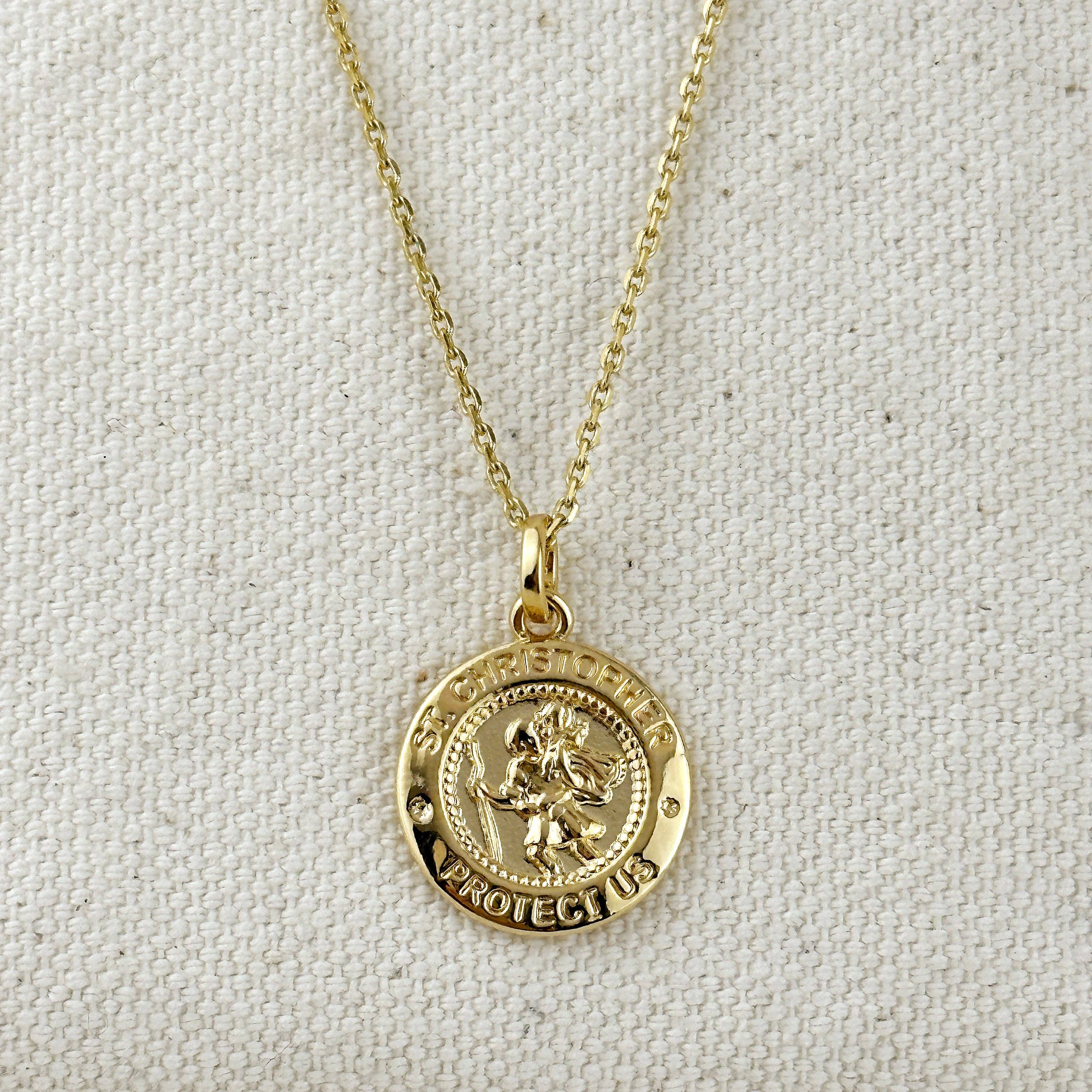 Gold necklace with a circular pendant on a light gray background. Shop Rutledge Exchange for curated vintage and jewelry in Camden, SC.&nbsp;