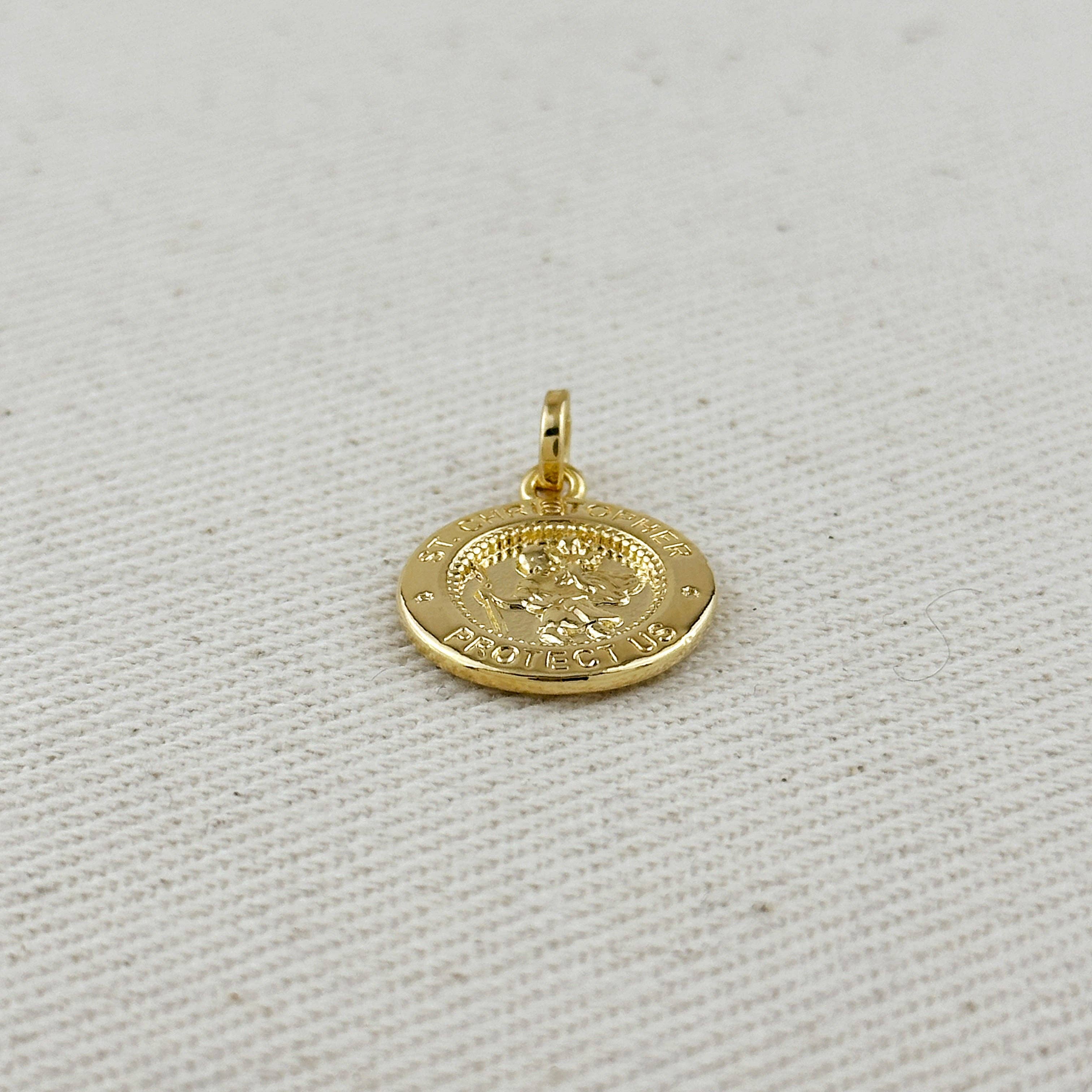 Gold pendant on a light gray fabric background. Shop Rutledge Exchange for curated vintage and jewelry in Camden, SC.&nbsp;