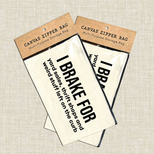 Canvas zipper bags with humorous text on a textured beige background. Canvas pouch with text on a white wooden background at Rutledge Exchange in Camden, SC.