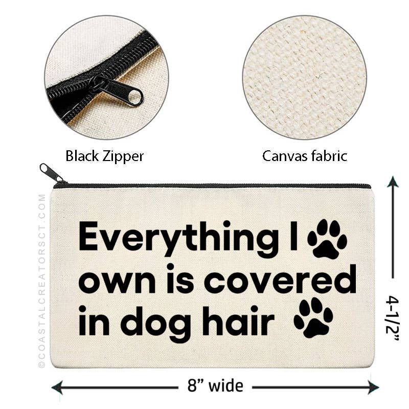 Canvas pouch with text 'Everything I own is covered in dog hair' and measurements, featuring a black zipper and paw prints. Rutledge Exchange is a boutique jewelry and antique store in Camden, SC. &nbsp;