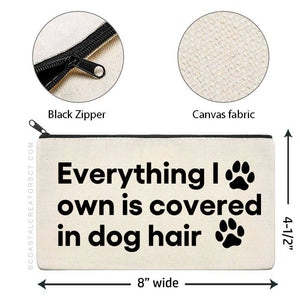 Canvas pouch with text 'Everything I own is covered in dog hair' and measurements, featuring a black zipper and paw prints. Rutledge Exchange is a boutique jewelry and antique store in Camden, SC. &nbsp;
