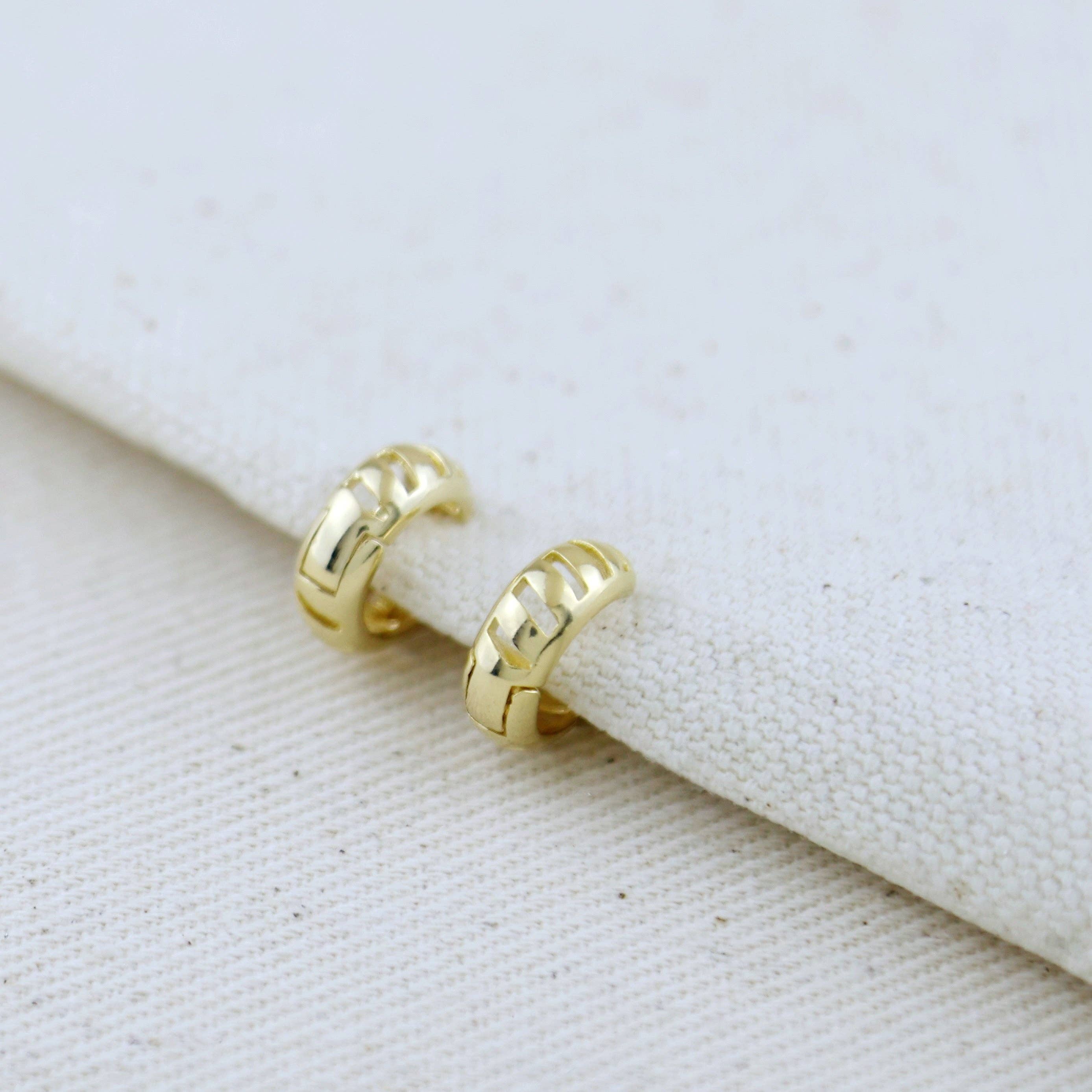 Gold hoop earrings on a white fabric background Shop Rutledge Exchange for curated vintage and jewelry in Camden, SC
