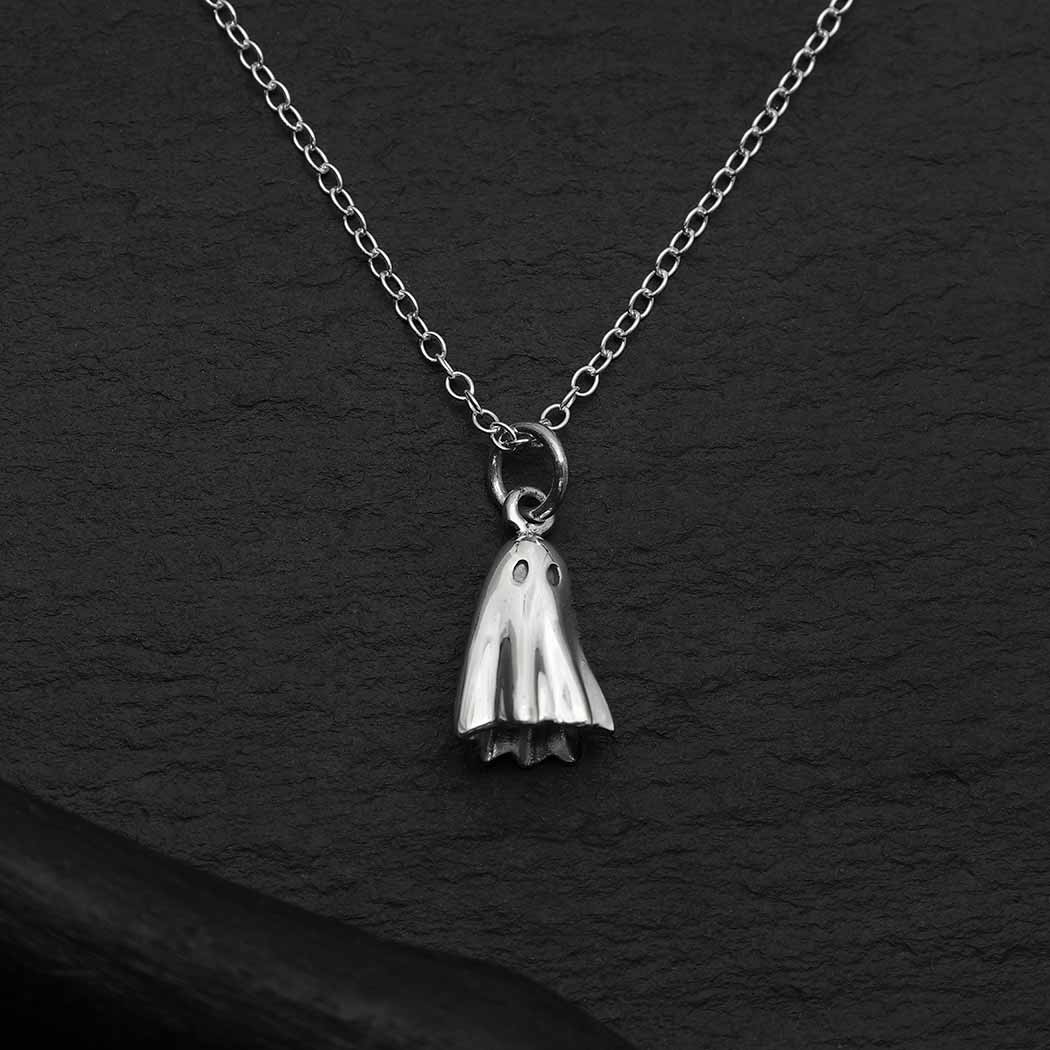 Playful and full of innocence, this sterling silver 3D ghost charm necklace is a whimsical way to celebrate the Halloween season. Children the world over make something scary into something playful when they throw on white sheets, play chase, and give each other a little fright. Offer this ghost charm necklace in the fall as a way to dress up on Halloween, and all year round. · Comes on a simple sterling silver 18" cable chain with spring ring clasp. 