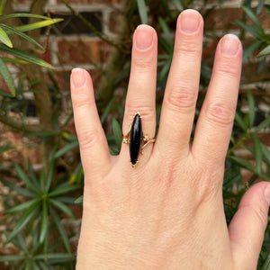 Crafted from high-quality materials, this ring is an exceptional example of the creativity and craftsmanship that went into the production of fine jewelry during the MidCentury period. Elongated Ring. Navette Onyx 10k Yellow Gold. Rutledge Exchange